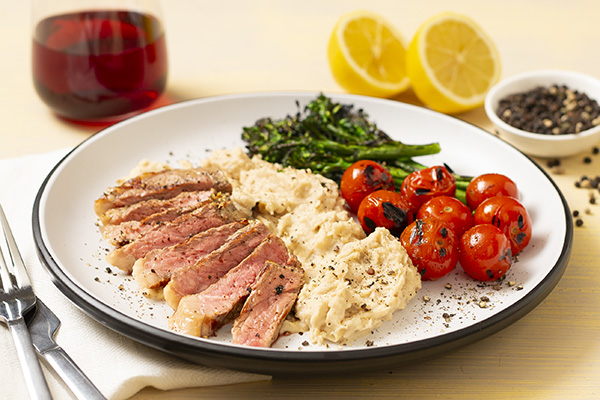 Porterhouse and Charred Broccolini with Blistered Cherry Tomatoes and White Bean Mash